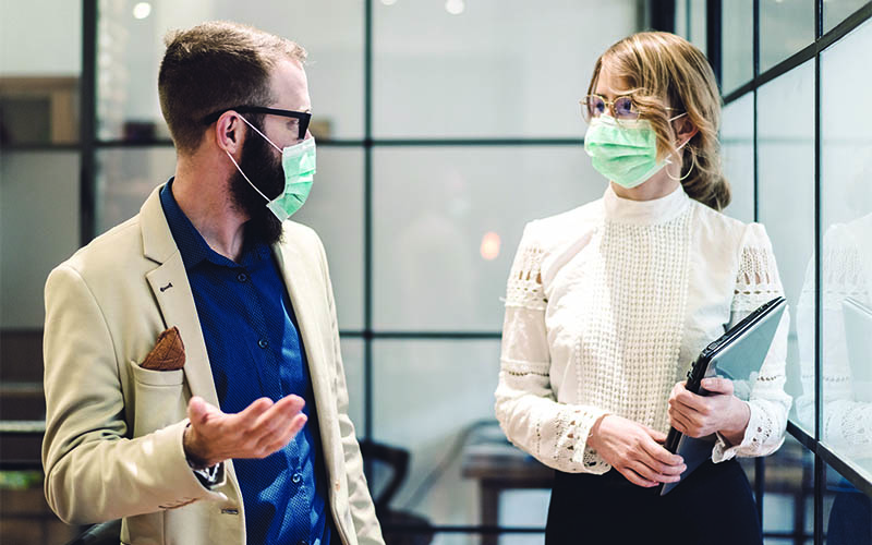 A man and woman with face masks