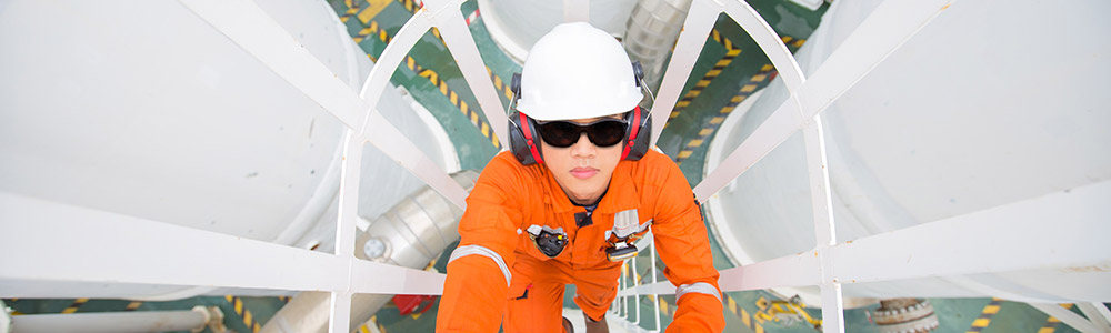 Worker climbing up a ladder