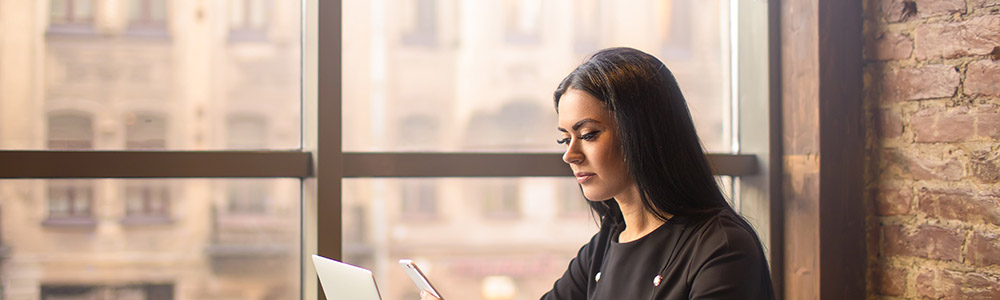 Business woman looking at her phone