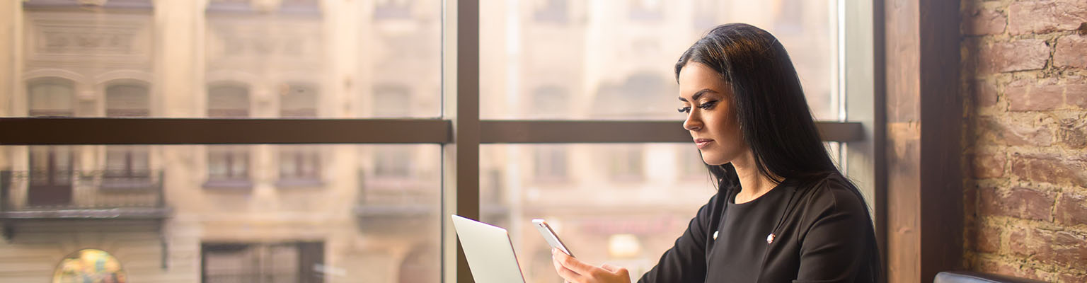 Business woman looking at her phone